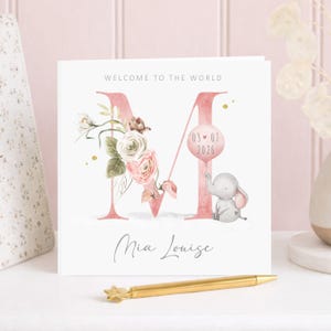 Custom baby girl greeting card with floral letter, elephant holding balloon with birth date, personalised newborn girl card pink theme