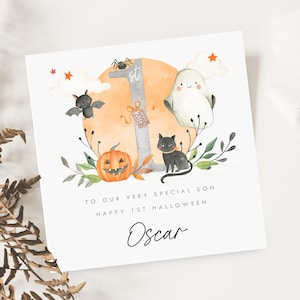 Personalised First Halloween Card for Baby. Custom Halloween Keepsake with Cute Ghost, Pumpkin, Black Cat, Bat, and '1st Halloween 2025' Design. Ideal for Son, Grandson, or Baby's First Halloween Gift. Features baby’s name and short personalised message. Perfect Halloween card for babies born in 2024 celebrating their first spooky season. Printed on quality 300gsm lightly textured cardstock, measures 148 x 148mm and is supplied with a blank recycled kraft envelope.