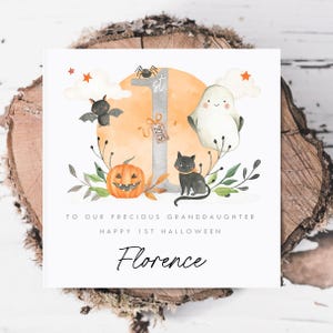 Personalised First Halloween Card for Baby. Custom Halloween Keepsake with Cute Ghost, Pumpkin, Black Cat, Bat, and '1st Halloween 2025' Design. Ideal for Son, Grandson, or Baby's First Halloween Gift. Features baby’s name and short personalised message. Perfect Halloween card for babies born in 2024 celebrating their first spooky season. Printed on quality 300gsm lightly textured cardstock, measures 148 x 148mm and is supplied with a blank recycled kraft envelope.