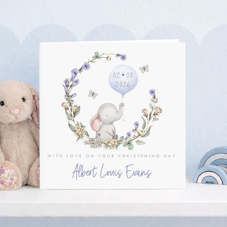 Personalised christening card for baby girl or boy featuring a cute little elephant illustration holding a balloon surrounded by a floral wreath. Perfect keepsake card suitable for christening, baptism, dedication day and more.
Custom name and date, pink or blue options. Printed on quality 300gsm lightly textured cardstock, measures 148 x 148mm and is supplied with a blank recycled kraft envelope.