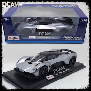 May include: A silver 1/18 scale diecast model of the 2021 Aston Martin Valkyrie, a limited edition special edition car model by Maisto.