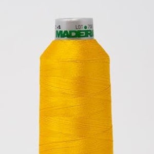 Pode incluir: Uma bobina de fio amarelo brilhante com o nome da marca "MADERA" impresso no rótulo.