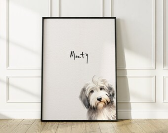 May include: A black framed print with a watercolor illustration of a dog's head. The dog is white and gray with a fluffy coat. The name "Monty" is written in black cursive above the dog's head.