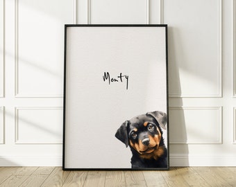 May include: A black framed print with a watercolor illustration of a Rottweiler puppy peeking out from the bottom right corner. The name "Monty" is written in black cursive at the top of the print.