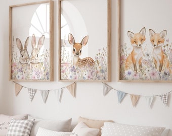 May include: Three framed watercolor prints of woodland animals in a nursery setting. The prints feature a rabbit, a deer, and two foxes. Each print has a white background with a floral border.