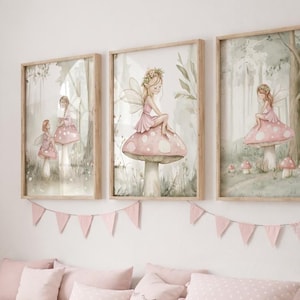 May include: Three framed watercolor prints featuring fairies in a forest setting. The fairies are depicted in pink dresses, sitting on mushrooms. A pink banner hangs below the prints, and a wooden storage bench with pink pillows and storage bins is below.