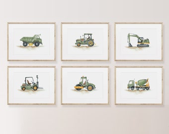 May include: Set of six framed prints featuring illustrations of different construction vehicles. The vehicles are all green with yellow accents and are depicted on a white background. The frames are light brown wood.