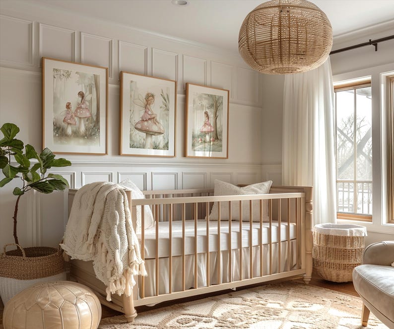 May include: A nursery with a light wood crib, a woven pendant light, and three framed watercolor prints of fairies. A woven basket and a potted plant are also visible. The room has a neutral color palette with white walls and a beige rug.