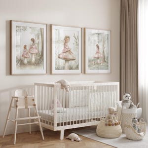 May include: Three framed watercolor prints of fairies in a forest setting, with soft pink and green hues. A white crib, high chair, and decorative baskets with stuffed animals are in the foreground, creating a nursery theme.