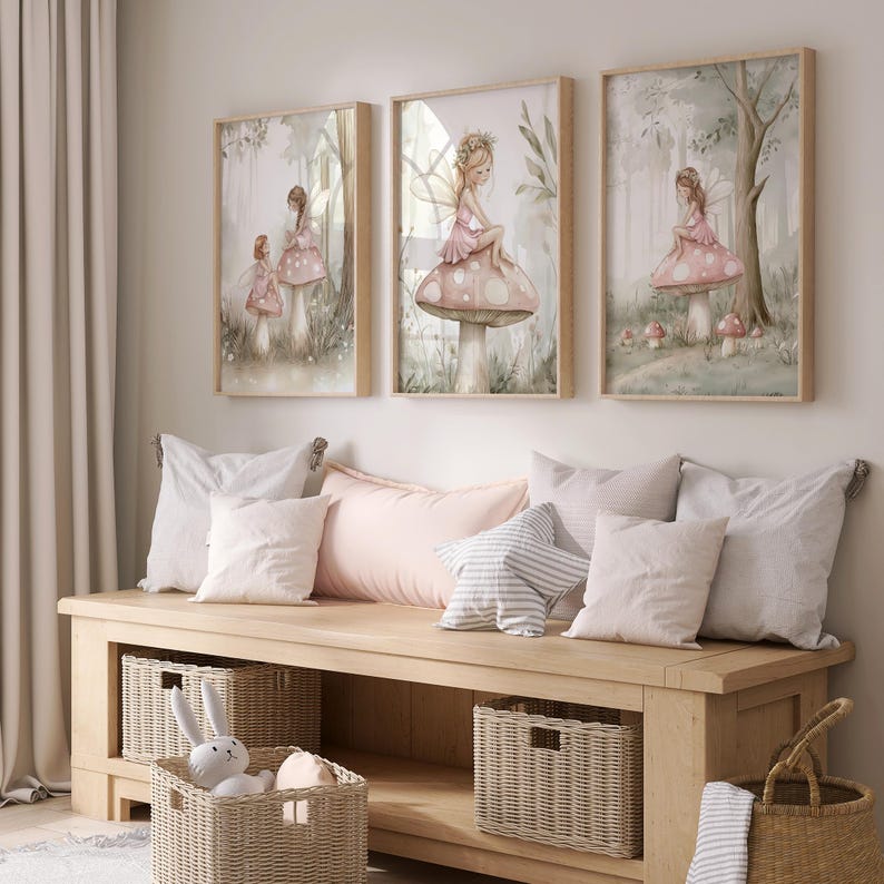 May include: Three framed watercolor prints of fairies in a forest setting. The fairies wear pink dresses and sit on mushrooms. The prints are displayed above a wooden bench with pillows and baskets. The color palette is soft, with muted greens, pinks, and beige.