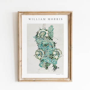 May include: A framed print of a floral design by William Morris. The design features white flowers with green and blue leaves on a cream background. The text "William Morris" is at the top of the print and "Anemone - 1875" is at the bottom.