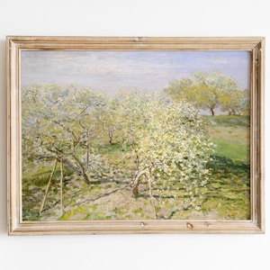 May include: A framed painting depicting a landscape with a field of blossoming trees in shades of white, green, and yellow. The trees are in the foreground, with a blue sky and white clouds in the background.