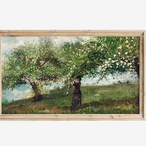 May include: A framed painting depicting a woman standing in a field under a blossoming tree. The woman is wearing a dark dress and a hat. The tree is in full bloom with white flowers. The background is a green field with a blue sky.