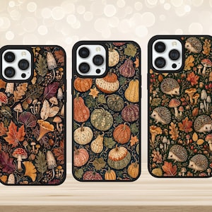May include: Three smartphone cases featuring distinct autumn-themed patterns. The left case displays mushrooms and fall leaves. The centre case shows various pumpkins and gourds. The right case features hedgehogs, mushrooms, and foliage.