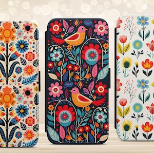 May include: Three phone cases with colourful floral and bird designs. The cases feature vibrant patterns of flowers, leaves, and birds in shades of red, orange, blue, and yellow. The cases are designed to protect the phone while adding a touch of artistic flair.