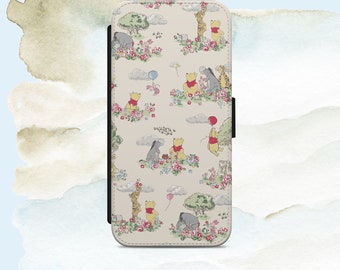 May include: A beige phone case with a Winnie the Pooh pattern. The case features Winnie the Pooh, Piglet, Tigger, and Eeyore in a whimsical woodland setting with flowers and clouds.