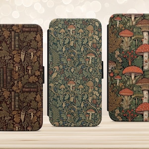 May include: Three rectangular phone cases featuring distinct patterns. The left case has a dark brown background with books, keys, and mushrooms. The middle case displays a green botanical mushroom pattern. The right case shows large red mushrooms.