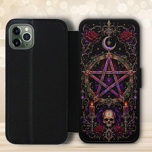 May include: A black wallet-style phone case featuring a detailed graphic print on the interior panel. The design displays a central pentagram, a crescent moon, a human skull, two lit candles, and red roses, all set against a dark, ornate background.