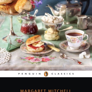 May include: A vintage book cover with a Penguin Classics logo. The cover features a still life image of a tea party with scones, jam, clotted cream, teacups, and sugar cubes. The title of the book is "Scone with the Wind" by Margaret Mitchell.