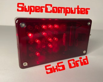 May include: A red, rectangular box with a grid of 25 red LEDs. The box has a clear plastic cover and is labelled "SuperComputer 5x5 Grid".