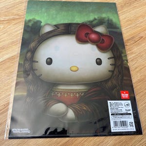 May include: A rectangular plastic clear file featuring a graphic of Hello Kitty styled as the Mona Lisa, with long brown hair, a red bow, and a dark dress. The background is a dark green landscape. Text includes Sanrio copyright details.