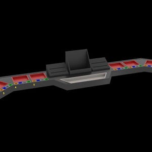 May include: A futuristic, gray console with red, blue, green, and yellow accents. The console has multiple rectangular compartments with red interiors, and a central raised section with a rectangular opening. The design is symmetrical.