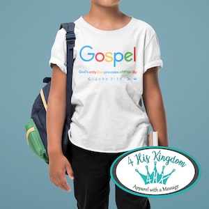 May include: White t-shirt with the word "Gospel" in colorful letters. The text "God's only Son provides eternal life" is below the word Gospel. The text "< John 3:16 >" is below the previous text. A crown symbol is to the right of the text. The t-shirt is being worn by a young person wearing headphones and a backpack. The image also includes a logo for "4 His Kingdom Apparel with a Message".