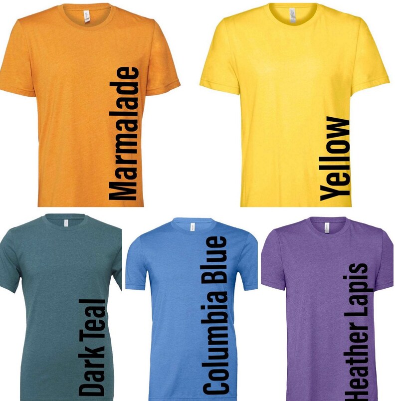 May include: Five t-shirts in different colors, each with a different color name printed vertically down the side. The colors are marmalade, yellow, dark teal, Columbia blue, and heather lapis.