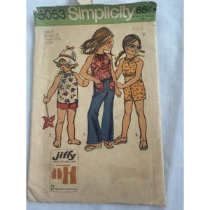 May include: Vintage Simplicity sewing pattern 5053 for children's clothing. The pattern features illustrations of three girls wearing halter tops, shorts, and flared jeans. The pattern includes the text "Jiffy easy cut easy sew".