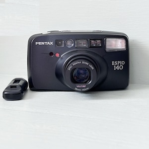 UNUSED  Pentax Espio 140 Full Orginal/Black Point and shoot 35 mm film camera,/ Orginal Leather Case/ original pentax remote