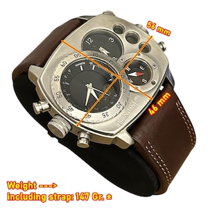 May include: A silver-toned Timberland watch with a brown leather strap. The watch face has multiple dials, including a tachymeter and compass. The watch measures 46 mm x 56 mm and weighs 147 grams including the strap.