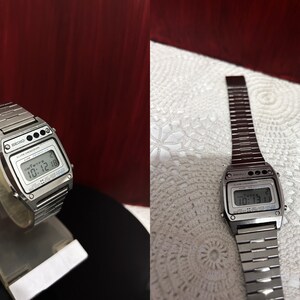 Puede incluir: Un reloj digital Seiko plateado con una correa de metal plateado. La esfera del reloj muestra la hora, la fecha y el d&iacute;a de la semana.