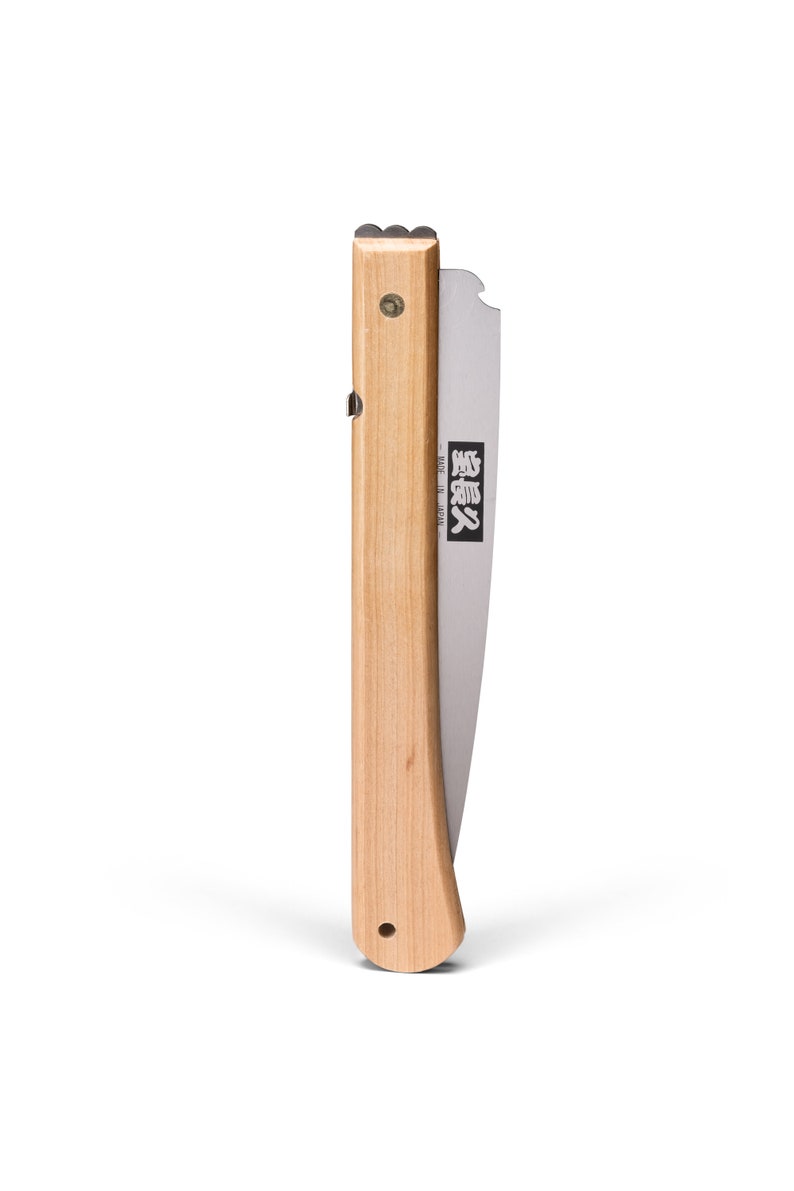 May include: A folding saw with a wooden handle and a silver blade. The blade has Japanese text that reads "Silky" and "Made in Japan".