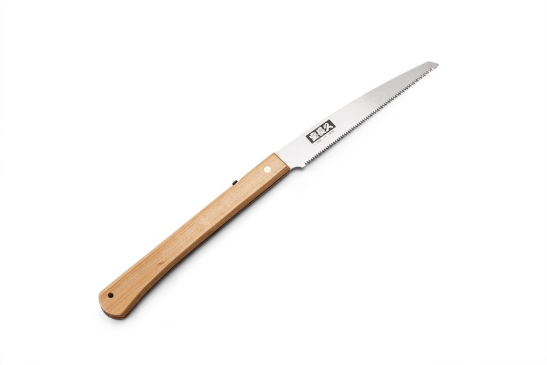May include: A folding saw with a wooden handle and a silver blade. The blade has a serrated edge and the text "Silky" is printed on the blade.