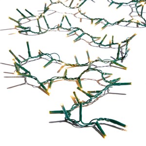 May include: Strands of Christmas lights with small, warm white bulbs on green wire. The lights are arranged in a loose, overlapping pattern against a white background, casting shadows. Ideal for holiday decorating or adding a festive touch.