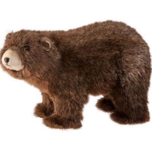 May include: A brown plush bear figurine with a light-colored snout and dark eyes. The bear is standing on all fours, with a shaggy fur texture. The figurine is a decorative item.