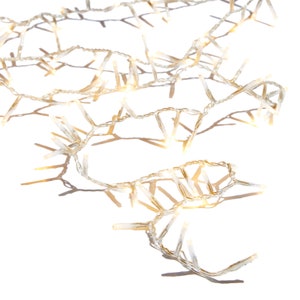 May include: A string of warm white LED Christmas lights on a white background. The lights are arranged in a cascading pattern, casting shadows. The lights are ideal for holiday decorations.