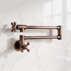 May include: A wall-mounted pot filler faucet with a dual-jointed swing arm and two cross-style handles. The fixture features a dark, brushed bronze finish with a metallic sheen, designed with a horizontal articulated arm and a circular base plate.