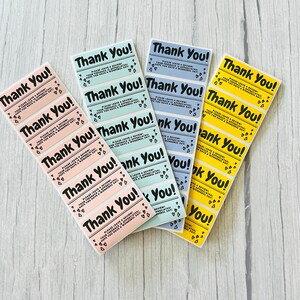 May include: Four vertical sheets of rectangular stickers in pastel pink, light blue, periwinkle, and yellow. Each sticker features the bold black text Thank You!, followed by Please leave a review! Your feedback is appreciated! Hope you have a wonderful day! and small heart icons.