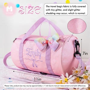 May include: A pink glittery duffel bag with light purple handles and a detachable shoulder strap. The bag features a rainbow-colored bow, the name Emily embroidered in purple, and ballet slipper icons. It measures 11 inches long and 7 inches high.
