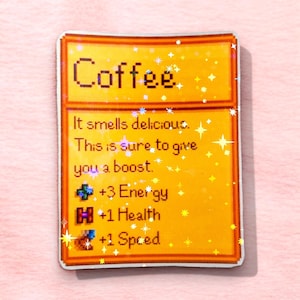 May include: A sticker with a pixelated design featuring the word "Coffee" at the top. The sticker has text that reads "It smells delicious. This is sure to give you a boost. +3 Energy, +1 Health, +1 Speed."