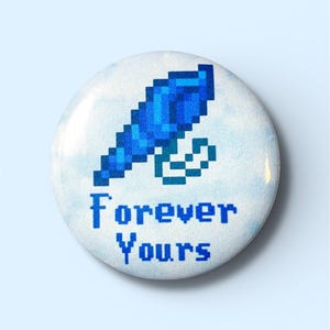 May include: A round button with a pixelated blue feather design and the words "Forever Yours" in blue. The background has a watercolor effect with shades of white and blue.