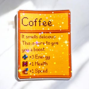 May include: A sticker with a pixelated design featuring the word "Coffee" at the top. Below, text reads "It smells delicious. This is sure to give you a boost." with stats for energy, health, and speed. The sticker has a yellow and orange color scheme.