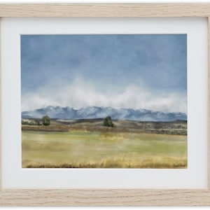 May include: A watercolor painting of a landscape with a mountain range in the background. The sky is a light blue with white clouds. The foreground is a field of grass with a few trees.