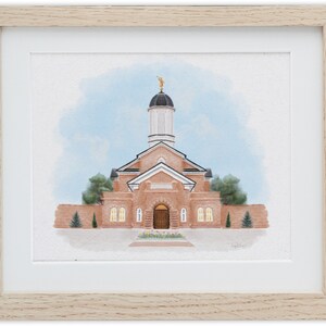May include: A watercolor painting of a brick building with a white steeple and a golden statue on top. The building has a large wooden door and windows. The building is surrounded by trees and bushes. The sky is blue with white clouds.