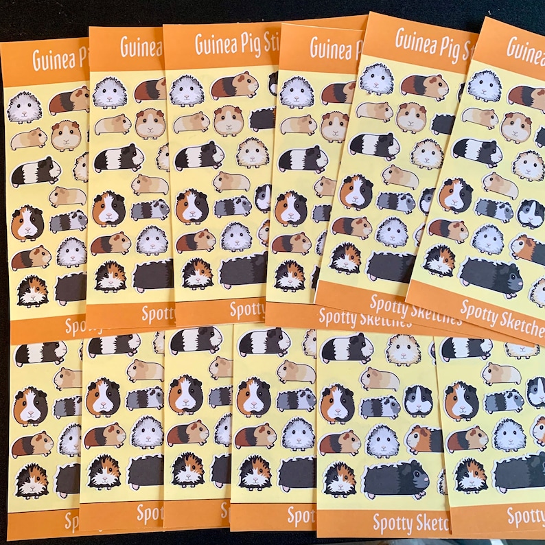 May include: A set of eight yellow and orange cards with illustrations of guinea pigs. Each card has the text "Guinea Pig Stickers" and "Spotty Sketches" printed on it. The cards are filled with colourful illustrations of guinea pigs in various poses.