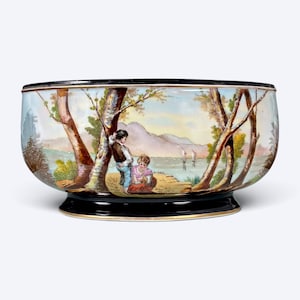 May include: A round ceramic bowl featuring a hand-painted landscape scene with two figures standing near trees by a lake. The bowl has a glossy black rim and a matching black base, with a gold-toned trim accenting the edges of the dark sections.