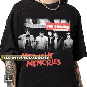 A black t-shirt with a graphic design featuring the members of the popular music group One Direction.