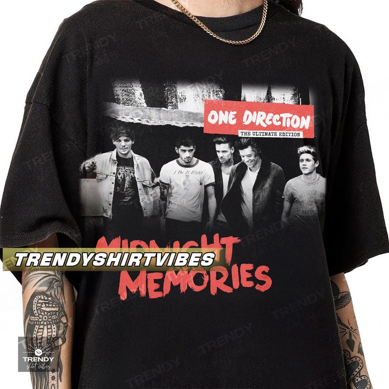 A black t-shirt with a graphic design featuring the members of the popular music group One Direction.