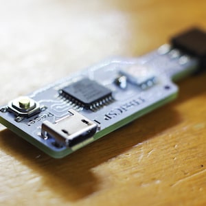 May include: A small circuit board with a micro USB port, a reset button, and the text "FT232R" printed on it.